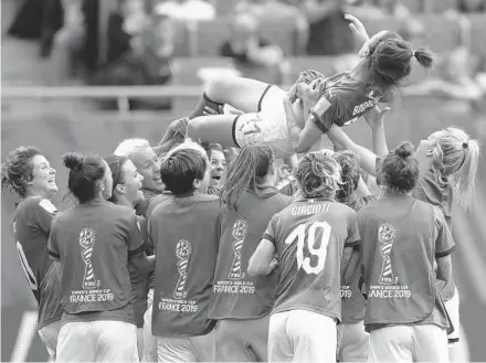  ?? FRANCISCO SECO/AP ?? Italy’s Barbara Bonansea is tossed into the air by teammates after a 2-1 victory in their Women’s World Cup match against Australia at the Stade du Hainaut in Valencienn­es on Sunday.