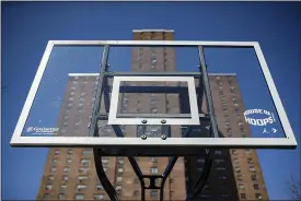  ?? JOHN MINCHILLO — THE ASSOCIATED PRESS ?? Basketball backboards stand without hoops after city officials had them removed to reduce gatherings at Holcombe Rucker Park in New York.