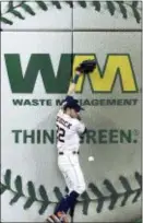  ?? MICHAEL WYKE — THE ASSOCIATED PRESS ?? Houston left fielder Josh Reddick loses the ball as he hits the wall on a single by the Yankees’ Neil Walker during the third inning on Thursday in Houston.