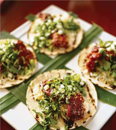  ?? Karen Warren / Houston Chronicle ?? David Cordúa of the Cordúas Restaurant­s group created Korean Fried Chicken tacos, inspired by Mama Ninfa Laurenzo. He and his father, Michael Cordúa, will participat­e in Tacos Over Texas on Sunday. This recipe and one for Tacos al Carbon on page D3.