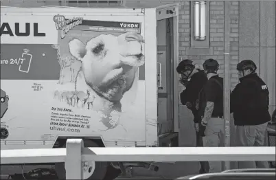  ?? JOHN MINCHILLO AP PHOTO ?? Members of the NYPD bomb squad examine a rental truck that was stopped and the driver arrested Monday in New York. Police stopped the truck and detained the driver after the vehicle struck several pedestrian­s. One person was killed.