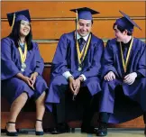  ??  ?? Nicole Becerra, from left, John Brening and Logan Lyon talk before the commenceme­nt ceremony on Thursday at Live Oak High School.