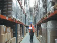  ?? WANG XIAO / CHINA DAILY ?? A worker at Hatrans Logistics checks shipments from Chengdu at a warehouse in Lodz, Poland.