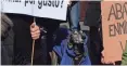  ?? PAUL
WHITE/AP ?? A dog takes part in a protest against the exclusion of some animals in Spain’s new animal protection law on Sunday in Madrid. The banner on left reads “Killing for pleasure?”