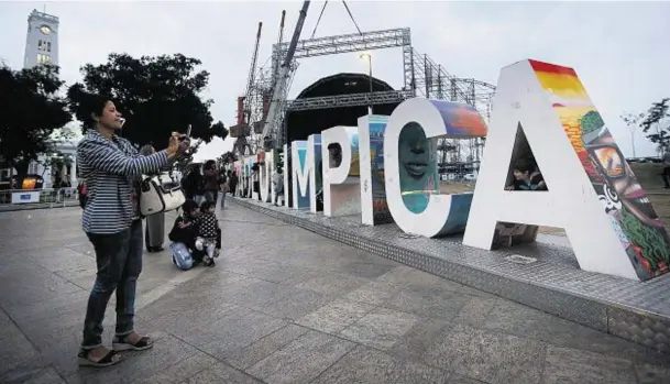  ??  ?? FOCAL POINT: People gather and take photos at the Cidade Olimpica sign in a section of the revamped Port District in Rio de Janeiro, Brazil