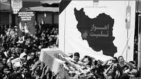  ??  ?? Iranians carry the body of one of those killed during an attack on a military parade, during a mass funeral for the victims in the southweste­rn Iranian city of Ahvaz. (Photo: Radio Farda)