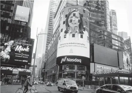  ?? KENA BETANCUR AFP VIA GETTY IMAGES ?? Airbnb was the biggest U.S. IPO this year. Airbnb’s logo is displayed on the Nasdaq digital billboard in Times Square in New York.