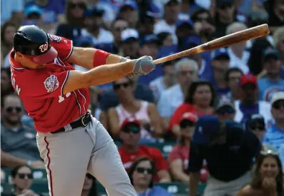  ?? Associated Press ?? ■ Washington Nationals' Ryan Zimmerman hits a three-run home run against the Chicago Cubs during the fourth inning of a baseball game Saturday in Chicago.