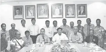  ??  ?? Mawan (seated at head of table) in a photo call together with Ikhmal (seated fourth left) and Kapitan Gan (standing fourth left) and longhouse chiefs after the meeting.