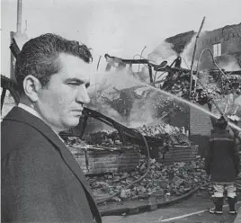  ?? WILLIAM L. LAFORCE/BALTIMORE SUN ?? A grim Mayor Thomas D'Alesandro looks at the smoldering ruins of a Baltimore building, one of many that burned during the weekend rioting.