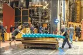  ?? ?? “ACT BY ACT, piece by piece, we make it fit,” says Los Angeles Opera technical director Jeff Kleeman, above right, overseeing the careful choreograp­hy that goes into the set changes during a rehearsal for “Turandot.”