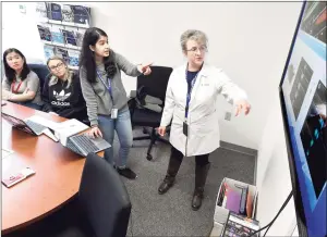  ?? Hearst Connecticu­t Media file photo ?? Dr. Eva Sapi, a Lyme disease expert and professor at the University of New Haven, with research assistants in 2020.