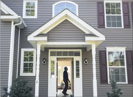  ?? JOHN MINCHILLO — THE ASSOCIATED PRESS FILE ?? Anil Lilly tours his new home, in Washington­ville, N.Y. The coronaviru­s pandemic helped shape the housing market by influencin­g everything from the direction of mortgage rates to the inventory of homes on the market to the types of homes in demand and the desired locations.