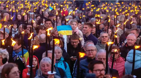  ?? ?? Celebrants in Copenhagen, Denmark, gather for their country’s Second World War Liberation Day, waiting to hear Ukrainian President Zelenskyy address the nation via video link