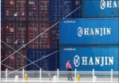  ?? CFP ?? A man stands in front of shipping containers at the Hanjin Shipping container terminal at Incheon New Port in South Korea on Wednesday.