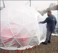  ?? Ned Gerard / Hearst Connecticu­t Media ?? Brewery manager Tom Hanley opens one of the new outdoor igloos at Dockside Brewery in Milford.