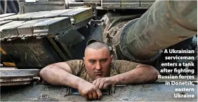  ?? ?? A Ukrainian serviceman enters a tank after fighting Russian forces in Donetsk, eastern Ukraine