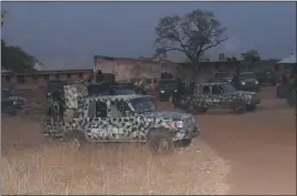  ?? THE ASSOCIATED PRESS ?? Nigeria army trucks are parked in an area where gunmen kidnapped school children from a school in Chikun, Nigeria, on Thursday.