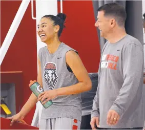  ?? JIM THOMPSON/JOURNAL ?? Ahlise Hurse, left, shares a laugh with Lobo women’s coach Mike Bradbury during Friday’s workout at the Davalos Center.