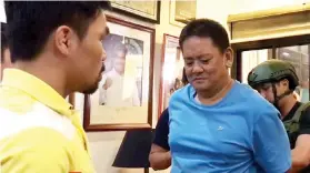  ?? POLITICAL AFFAIRS OFFICE OF SEN. MANNY PACQUIAO ?? Maasim town Mayor Aniceto Lopez Jr., center, surrenders to Sen. Emmanuel “Manny” Pacquiao, left, several hours after the raid on his home.