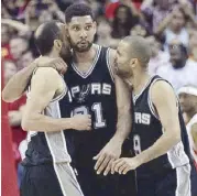  ?? AP ?? San Antonio Spurs forward Tim Duncan (21) receives a hug from Manu Ginobili (left) and Tony Parker after Duncan blocked a layup attempt by Houston Rockets guard James Harden at the buzzer.