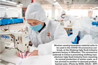  ?? (Photo by NOEL CELIS / AFP) ?? Workers sewing hazardous material suits to be used in the COVID-19 coronaviru­s outbreak, at the Zhejiang Ugly Duck Industry garment factory in Wenzhou. The coronaviru­s outbreak in China is preventing clothing manufactur­er Ugly Duck Industry from resuming its normal production of winter coats, so it has pivoted to another in-demand product: hazmat suits.