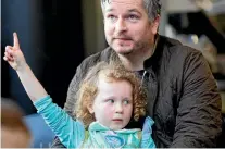  ?? ROSS GIBLIN / STUFF ?? Budding 7-year-old poet Tama Marchant, main photo, and 5-year-old Winifred Budding with dad Edwin, enjoy yesterday’s opening of Wellington City Library’s Beyond the Page festival.