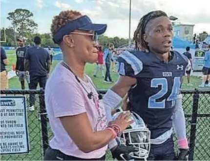  ?? RICK ROBB/SPECIAL TO THE POST ?? Robin Age (left) joins her son, defensive back CJ Gilmore, before serving as one of Keiser University’s honorary captains Saturday evening in a tribute to Breast Cancer Awareness Month.