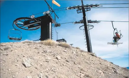  ?? Max Whittaker Getty Images ?? SKIERS RIDE a chairlift over dry ground at Squaw Valley Ski Resort in March. Many resorts have closed early because of the drought.