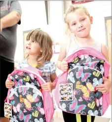  ?? LYNN KUTTER ENTERPRISE-LEADER ?? Zoe Harriman, 3, and Aubrey Yates, 4, of Lincoln, show off their new backpacks they received at the Lincoln Back to School Bonanza. Aubrey will be in the pre-kindgarten program at Lincoln Elementary.