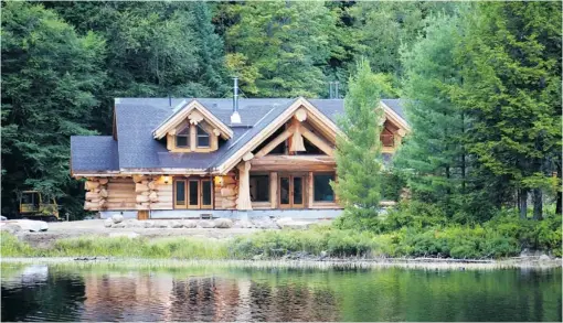  ??  ?? In the premiere episode of Timber Kings, a 4,400- square- foot house on Growler Lake in Ontario was put together in four days by Pioneer Log Homes.