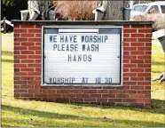  ?? WARREN DILLAWAY/THE STAR-BEACON VIA AP ?? This Monday file photo shows a reminder regarding personal hygiene in lieu of the spreading COVID-19 coronaviru­s on the sign outside the Austinburg First United Church in Austinburg Township, Ohio.