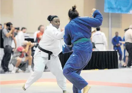  ?? PHOTOS BY GARY CURRERI ?? Above, Fort Lauderdale’s LaQuinta Allen, left, made a successful return to the mat with a gold medal performanc­e at the 2015 Palm Beach County Sports Festival. Below, Santiago Toledo, left, scores a point during his championsh­ip showing against James...