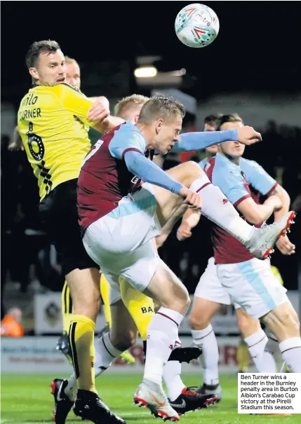  ??  ?? Ben Turner wins a header in the Burnley penalty area in Burton Albion’s Carabao Cup victory at the Pirelli Stadium this season.