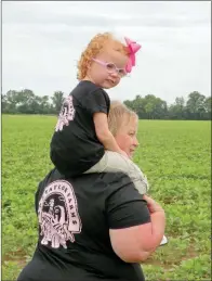  ??  ?? Jennifer Taylor and her 3-year-old granddaugh­ter, Lanie Paige McElyea, show off the special T-shirts Jennifer made for them, highlighti­ng J&J Taylor Farms.