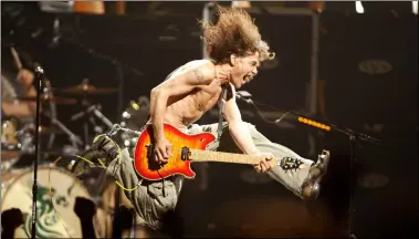  ?? ASSOCIATED PRESS FILE ?? Eddie Van Halen plays the final chord of “Jump” during the Van Halen concert at the Continenta­l Airlines Arena in East Rutherford, N.J. in June 2004