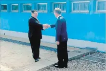  ?? THE ASSOCIATED PRESS ?? In this image from Korea Broadcasti­ng System, North Korean leader Kim Jong Un, left, shakes hands with South Korean President Moon Jae-in.