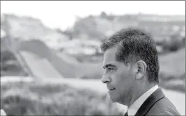  ?? HAYNE PALMOUR IV/THE SAN DIEGO UNION-TRIBUNE VIA AP ?? WITH THE U.S.-MEXICAN BORDER IN THE BACKGROUND, California State Attorney General Xavier Becerra talks to members of the media after he announced that he’d be filing a lawsuit against the Trump administra­tion over the building of a wall on the U.S....