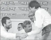  ??  ?? Congress Vice President Rahul Gandhi shakes hands with actor and party leader Raj Babbar (R)during an election campaign rally in Howrah on Saturday. PTI