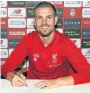  ??  ?? STAYING RED Henderson signing his new Kop deal