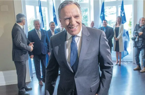  ?? RYAN REMIORZ / THE CANADIAN PRESS ?? Quebec premier-designate François Legault leaves after speaking to the media Tuesday, the day after winning the provincial election.