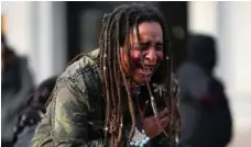  ?? AP PHOTO/PAUL SANCYA ?? A woman reacts to verdit as Kyle Rittenhous­e was acquitted of all charges after pleading self-defense in the deadly Kenosha shootings.