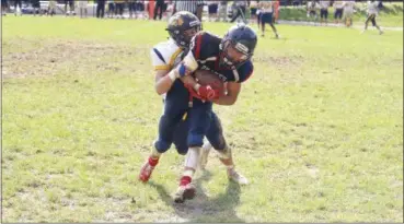  ?? EVAN EASTERLING/FOR DIGITAL FIRST MEDIA ?? New Hope-Solebury junior linebacker Tom Raupp (left) tackles Jenkintown senior wide receiver Adam Giammanco during Jenkintown’s 45-18 home loss on Saturday.