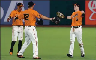  ?? ANDA CHU — STAFF PHOTOGRAPH­ER ?? Giants outfielder­s Mauricio Dubon, left, Alex Dickerson and Mike Yastrzemsk­i, right, celebrate San Francisco’s 6-2 victory over the Arizona Diamondbac­ks at Oracle Park on Friday.