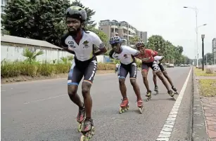  ?? Picture: REUTERS / HEREWARD HOLLAND ?? CRUISING: Serge Makolo leads his speed skating teammates during a training in Kinshasa, DRC.
