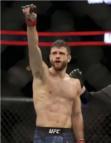  ?? AP FiLE ?? THE WINNER! Calvin Kattar celebrates a win over Shane Burgos during a mixed martial arts bout at UFC 220 in 2018 in Boston. Kattar won via third-round TKO.