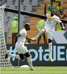  ?? /Gavin Barker/BackpagePi­x ?? Joy of a goal: Pape Gueye, left, celebrates his goal with Senegal teammate Lamine Camara in their 3-0 win over Gambia in Ivory Coast on Monday.