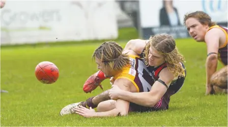  ?? ?? Above: Contesting the ball at ground level during the reserves are Drouin’s Sam Rippon and Bairnsdale’s Max East.