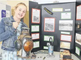  ?? LYNN CURWIN/TRURO NEWS ?? Ella Rogers, a Chiganois Elementary School student, used items her family had saved to put together her heritage fair project on the history of trains in the Truro area. The fair was held at the NSCC on May 3.