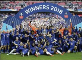  ?? TIM IRELAND — THE ASSOCIATED PRESS ?? Chelsea players and staff celebrate after winning the English FA Cup final soccer match between Chelsea and Manchester United at Wembley stadium in London, Saturday. Chelsea defeated Manchester United 1-0.